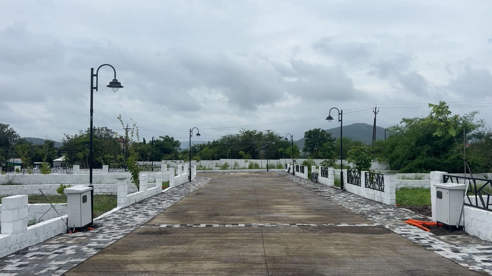 The Vana Estate — entrance road with boundary walls